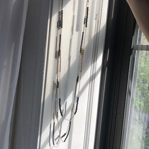 Three gold chains with black and gold beads